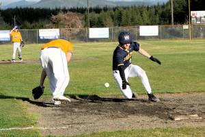 Spartan Landen Olson slides into third with a triple then scores on an overthrow.  Photo by Lonnie Archibald.