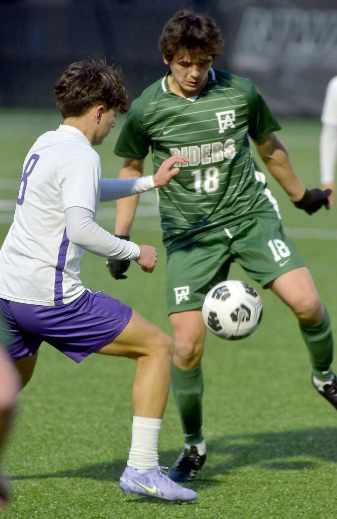 KEITH THORPE/PENINSULA DAILY NEWS
Port Angeles' Oliver Martinez, right, keeps the ball away from North Kitsap's Sebastian Moran during Friday night's match at Wally Sigmar Field.