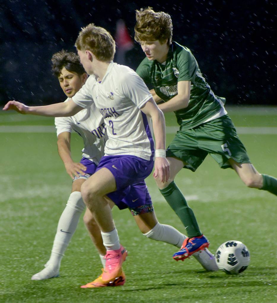 KEITH THORPE/PENINSULA DAILY NEWS
Port Angeles' Harper Willis, right, pushes North Kitsap's Ryder Doherty, center, and Bryan Miontes de Oca away from the ball on Friday night in Port Angeles.