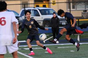 Lonnie Archibald/for Peninsula Daily News 
Forks Orlando Camacho kicks the ball past Hoquiam defenders including Israel Rosales (6). Also in action for Forks is Margarito Gonzalez Black (11). The Spartans scored four second-half goals to beat the Grizzlies 5-1.