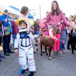 Heath Wade, 5, leads the goat parade to open the 37th annual Port Townsend Farmers Market on Saturday in the uptown neighborhood. Behind are goat wranglers Lindsey Kotzebue and Amber Langley of Port Townsend. (Steve Mullensky/for Peninsula Daily News)