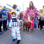 Heath Wade, 5, leads the goat parade to open the 37th annual Port Townsend Farmers Market on Saturday in the uptown neighborhood. Behind are goat wranglers Lindsey Kotzebue and Amber Langley of Port Townsend. (Steve Mullensky/for Peninsula Daily News)