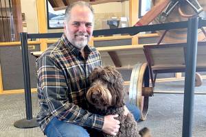 Kelly Kidwell, a local business owner and property developer, is purchasing Rite Bros. with the intention of building a long-term sustainable business that will expand aviation access in the area. Citizen Air, based at William R. Fairchild International Airport, will offer charter flights and fractional aircraft ownership. The possibility of scheduled flights could be in the distant future. Kidwell is shown with his Poodle-Bernese mountain dog, Porter. (Paula Hunt/Peninsula Daily News)