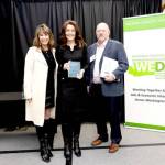 Clallam County Economic Development Council Director of Operations Lorie Fazio, left, and Executive Director Colleen McAleer stand with Michael Cade, executive director of Thurston EDC who presented the WEDAs 2025 Innovation in Economic Development award. The EDC received the award last month in recognition of its Clallam Forest Product Innovation Program.