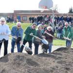 From left, Port Angeles school board members Sarah Methner, Mary Hebert, Stan Willams, Superintendent Marty Brewer, Kirsten Williams, Sandy Long and Nolan Duce, the districts director of maintenance, turn the first shovel of dirt on Saturday at the location of the new construction just north of the present Stevens Middle School. An estimated crowd of 150 attended the ceremonial ground breaking. (Dave Logan/for Peninsula Daily News)