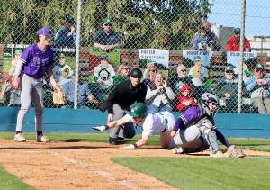 Dave Logan/for Peninsula Daily News
Port Angeles Trae Hanan reaches out to tag home plate before North Kitsap catcher Greyson Prichard can tag him out. He was safe for the second run of the game for the Roughriders.