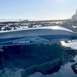 A 15-foot pleasure craft sits capsized at Koitlah Point on Thursday. U.S Coast Guard, local and federal agencies responded to a report of an overdue vessel with three people on board after they failed to return Wednesday evening. (U.S. Coast Guard)