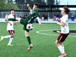 Port Angeles' Kanyon Anderson battles for a ball against Kingston on Friday. The Roughriders won their fourth league game in a row 4-2 over the Buccaneers, putting their record at 6-2 in league. Anderson had an assist and drew a foul that led to another goal. (Dave Logan/for Peninsula Daily News)