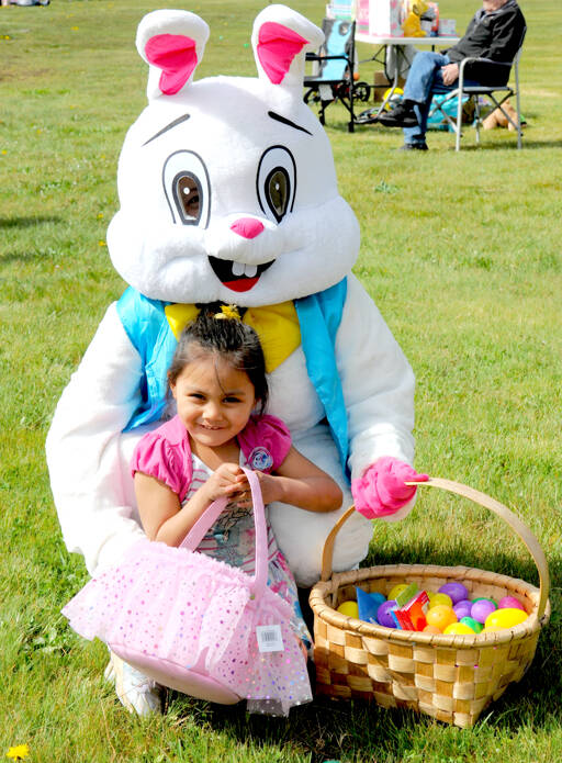 Danny Tenoria, 4, of Forks became friends with the Easter Bunny on Saturday afternoon at Tilicum Park in Forks. Children 12 and younger were divided into three groups to take part in the Forks Elks Lodge Easter Egg hunt. Many gifts, including several bicycles, were given out as prizes. (Lonnie Archibald/for Peninsula Daily News)