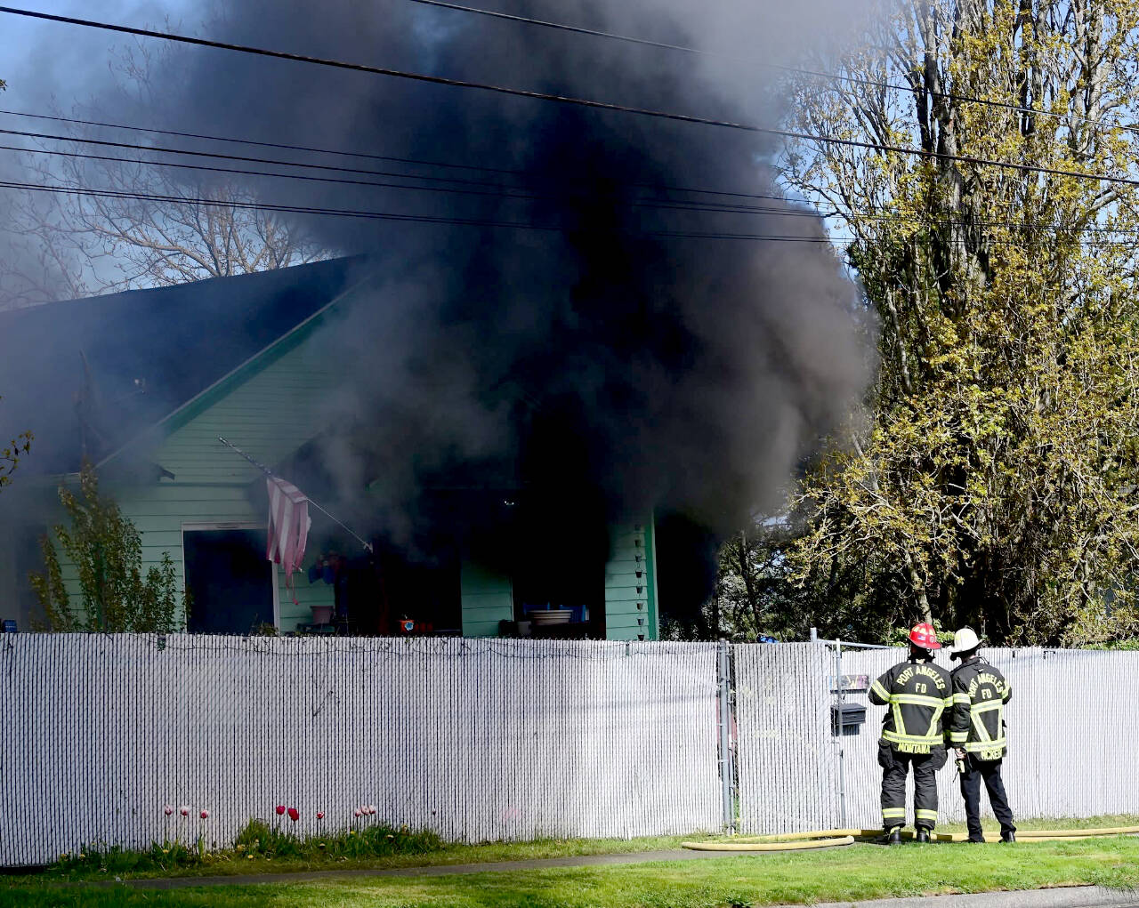 The Port Angeles Fire Department responds to a residential structure fire on West Eighth Street in Port Angeles on Tuesday. (Jay Cline via Port Angeles Fire Department)