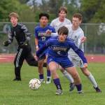 Sequim's Finn Braaten (5) and Evan Cisneros (17) battle for the ball against Port Angeles' Sawyer Davis (6). Port Angeles goalkeeper Gus Halberg (1) is also in on the play. Sequim won the crucial game 1-0 Friday in Sequim. (Emily Mathiessen/Olympic Peninsula News Group)