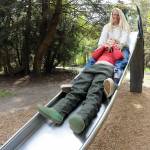 Leah Kendrick of Port Angeles and her son, Bo, 5, take a tandem ride on the slide in the playground area of the campground on Thursday at the Dungeness County Recreation area northwest of Sequim. The pair took advantage of a temperate spring day for the outdoor outing. (Keith Thorpe/Peninsula Daily News)