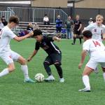 The East Jefferson Rivals met the Seattle Christian soccer team in a District 3 1A playoff match Saturday at Peninsula College. Here, East Jeffersons Alan Morales (8) tries to control the ball against Seattle Christian defenders. (Dave Logan/for Peninsula Daily News)