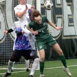 KEITH THORPE/PENINSULA DAILY NEWS Port Angeles Grant Butterworth, front, tries to steer an incoming corner kick as Olympics Jackson Wyall and goalkeeper Mariano Pena defend the net during Saturdays playoff game at Peninsula College.