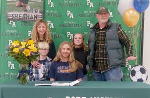 Port Angeles Ava-Anne Sheahan signed to play soccer for Corban University in Salem, Ore., last week surrounded by her family, from left, mother Megan Shean, brother Axel Johnston, sister Addy Johnston and father Bucky Johnston. (Pierre LaBossiere/Peninsula Daily News)