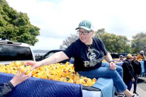 Port Angeles Mayor Kate Dexter is one of several local people who helped pluck a winning duck from a pickup truck on Sunday at Port Angeles City Pier. There was 36 ducks to be plucked from six Wilder Toyotas. (Dave Logan/For Peninsula Daily News)