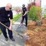 Port Angeles Fire Department Capt. Travis McFarland, left, and firefighter/EMT Tom Muir spread landscaping bark as part of a project to beautify the landscape around the fire hall. Fire department personnel spent time on Tuesday sprucing up the station grounds. (Keith Thorpe/Peninsula Daily News)