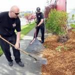 Port Angeles Fire Department Capt. Travis McFarland, left, and firefighter/EMT Tom Muir spread landscaping bark as part of a project to beautify the landscape around the fire hall. Fire department personnel spent time on Tuesday sprucing up the station grounds. (Keith Thorpe/Peninsula Daily News)