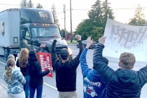 Family, friends and co-workers give Corey Alton a spirited send-off to celebrate the final shift of the Port Angeles driver's 36 years with UPS. Alton drove about 3.5 million miles over the course of his career without an accident or a ticket. (Paula Hunt/Peninsula Daily News)