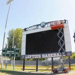 KEITH THORPE (2)/PENINSULA DAILY NEWS 
A crew from Olympic Electric installs a new scoreboard at Port Angeles Civic Field on Tuesday.
