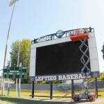 KEITH THORPE/PENINSULA DAILY NEWS A crew from Olympic Electric installs a new scoreboard at Port Angeles Civic Field on Tuesday.