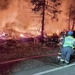 First responders assess a structure fire Thursday night on U.S. Highway 101 between Quilcene and Brinnon. (Jefferson County Sheriffs Office via X)