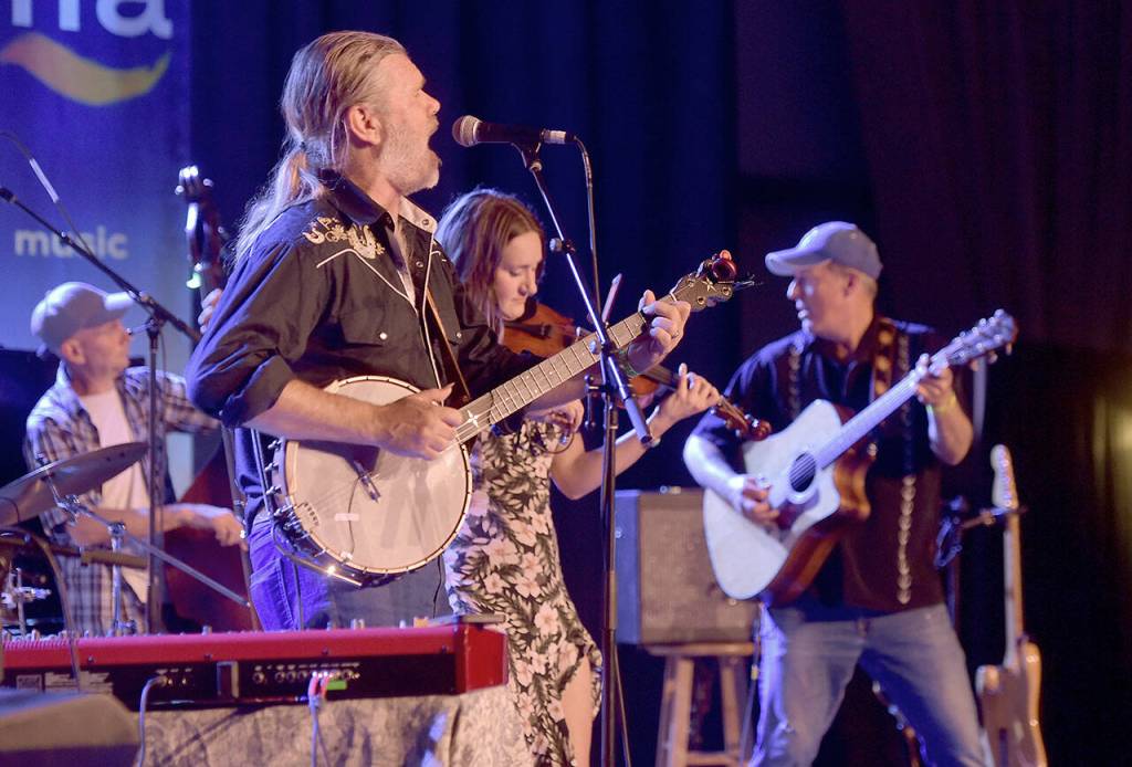 Poor Mans Whiskey, from left, bassist Mark Murphy, band leader Josh Brough, guest fiddler Chandra Johnson and co-founder Jason Beard command the Main Stage at the Juan de Fuca Festival on Saturday. (Keith Thorpe/Peninsula Daily News)
