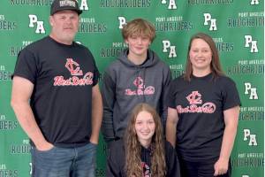 Port Angeles Zoe Ernst signs to play soccer for Lower Columbia College surrounded by her, from left, father Jaxon Ernst, brother Clayton Ernst and mother Emily Ernst. (Port Angeles High School)