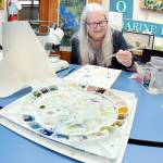 Barbara Westrem of Sequim paints her impressions of microscopic marine creatures during an adult drawing class on Wednesday at Feiro Marine Life Center in Port Angeles. The class, Through the Looking Glass!, gives participants a chance to work with professional artists to create works based upon what they observe. More information can be found at https://feiromarinelifecenter.org/through-the-looking-glass-adult-drawing-class-with-microscopes/. (KEITH THORPE/PENINSULA DAILY NEWS)