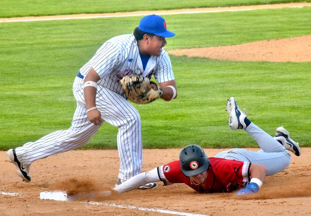 KEITH THORPE/PENINSULA DAILY NEWS
Lefties first baseman Eric Valdivia, left, catches Kamloops baserunner Ethan Kodama off the bag for an out during Friday night's home opener at Port Angeles Civic Field.
