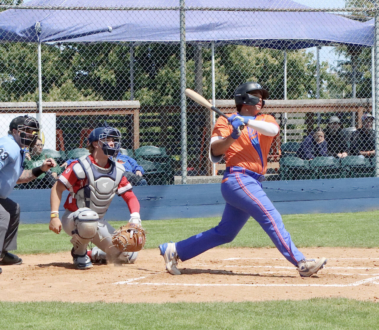 Port Angeles Dom Dominguez gets a hit for an RBI against Kamloops at Civic Field on Sunday. (Dave Logan/for Peninsula Daily News)