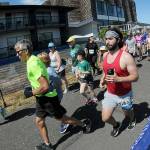 KEITH THORPE/PENINSULA DAILY NEWS
Runners take off from the start of Saturday's combined 5k and 10k races of the Olympic Discovery Marathon along the Waterfront Trail from Port Angeles City Pier,