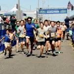 KEITH THORPE/PENINSULA DAILY NEWS Runners take off from the start of Saturdays combined 5k and 10k races of the Olympic Discovery Marathon along the Waterfront Trail from Port Angeles City Pier,