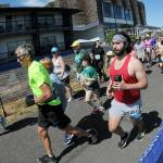 KEITH THORPE/PENINSULA DAILY NEWS Runners take off from the start of Saturdays combined 5k and 10k races of the Olympic Discovery Marathon along the Waterfront Trail from Port Angeles City Pier,