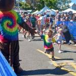 A young runner in the North Olympic Discovery Marathons kids marathon gets a high-five at the starting line Saturday at the Port Angeles City Pier. (Pierre LaBossiere/Peninsula Daily News)