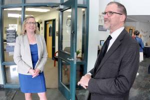 Retiring Port Angeles School District Superintendent Marty Brewer, right, shares a career experience as his replacement, Michelle Olsen, listens during a retirement gathering on Thursday at Lincoln Center in Port Angeles. (Keith Thorpe/Peninsula Daily News)