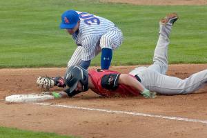 KEITH THORPE/PENINSULA DAILY NEWS
Lefties first baseman Will White tries to catch Seattle Gumberoos baserunner Eoin Buechs off the bag during Thursday's game at Port Angeles Civic Field.