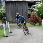 Tyler Klansnic of lake Forest Park wins the 80-mile Gravel Unravel race crossing the finish line at Worthington Park in Quilcene just two second ahead of Ben Schauland of Seattle.