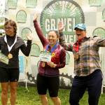 The top three finishers in the womens masters short course race of the Gravel Unravel this weekend celebrate in Quilcene receiving their medals. From left are Jennifer Ritter of Boise, Idaho, third, Emiko Atherton of Seattle, first, and Shaun Baesman of Bainbridge, second. (David Goetze)