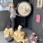 Fiber artist Angie Dideum installs the Steampunk in Fiber exhibit in Uptown Port Townsend.