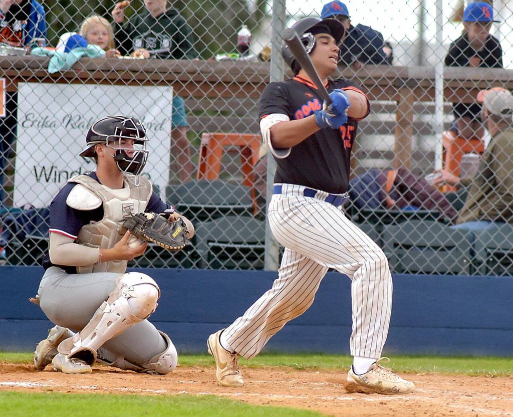 KEITH THORPE/PENINSULA DAILY NEWS Leftiies Don Dominguez bats in the second inning as Kelowna catcher Caden Mitchell receives the delivery on Thursday in Port Angeles.