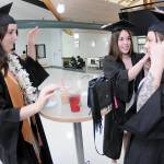 Peninsula College nursing students, from left, Emily Haddock of Lewiston, Idaho, Jordan Hegtvedt of Sequim and Chaela Cashman of Port Angeles adjust each others mortar boards in preparation for commencement ceremonies on Saturday on the colleges Port Angeles campus. A total of 328 students were expected to take part in two ceremonies with 530 students eligible for diplomas and certificates for the 2024-25 academic year. (Keith Thorpe/Peninsula Daily News)