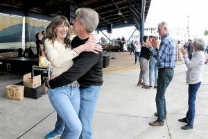 Lorna Kay Smith and Philip Wade, both of Sequim, dance to the music of Roses Pawn Shop to kick off the Concert on the Pier music series on Wednesday evening at Port Angeles City Pier. The series, presented by the Juan de Fuca Foundation and sponsored by Strait View Credit Union, D.A. Davidson & Co., 102.1 FM The Strait and Peninsula Daily News, continues at 6 p.m. Wednesday with the Wild Rumors band. (Keith Thorpe/Peninsula Daily News)