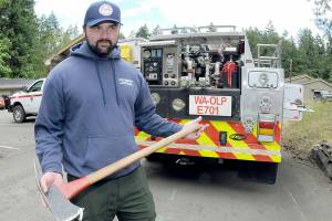 Jeff Bortner, Interagency Fire Management Officer employed by Olympic National Park, explains the history of a Pulaski tool often carried by wildland firefighters. (Keith Thorpe/Peninsula Daily News)
