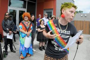Jaiden Dokken, former Clallam County poet laureate and grand marshal of the 2025 Sequim Pride Parade, addresses the audience of Sequim Pride from the steps of Sequim City Hall during Saturdays Sequim Farmers & Artisans Market. The event, celebrating Pride Month to honor the areas LGBTQIA2S+ community, featured speeches and a march around downtown Sequim with more than 200 participants followed by a group photo at the city hall plaza. (Keith Thorpe/Peninsula Daily News)