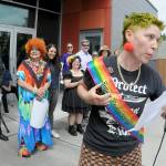 Jaiden Dokken, former Clallam County poet laureate and grand marshal of the 2025 Sequim Pride Parade, addresses the audience of Sequim Pride from the steps of Sequim City Hall during Saturdays Sequim Farmers & Artisans Market. The event, celebrating Pride Month to honor the areas LGBTQIA2S+ community, featured speeches and a march around downtown Sequim with more than 200 participants followed by a group photo at the city hall plaza. (Keith Thorpe/Peninsula Daily News)