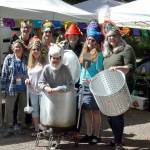 From left to right: Liz Klein, Parker Shaw, Edie Holy, Mel Luedders, Inés Shaw, Ted Lockery, Laurie Hampton and Emily Teachout prepare for Wednesday nights crazy hat party. Inés got in the 100-quart stock pot wearing her unicorn hat. (ELIJAH SUSSMAN/PENINSULA DAILY NEWS)