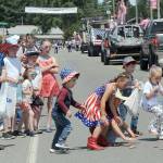 Children pick up candy along the parade route in Forks on Friday during the Forks Old Fashioned 4th of July Parade. (Lonnie Archibald/for Peninsula Daily News)