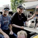 Black Ball Ferry Line co-owners Rian Anderson, vice president of terminal operations, left, and Ryan Burles, president and chief operating officer, ride through the streets as grand marshals of the Port Angeles Independence Day parade on Friday. (Keith Thorpe/Peninsula Daily News)