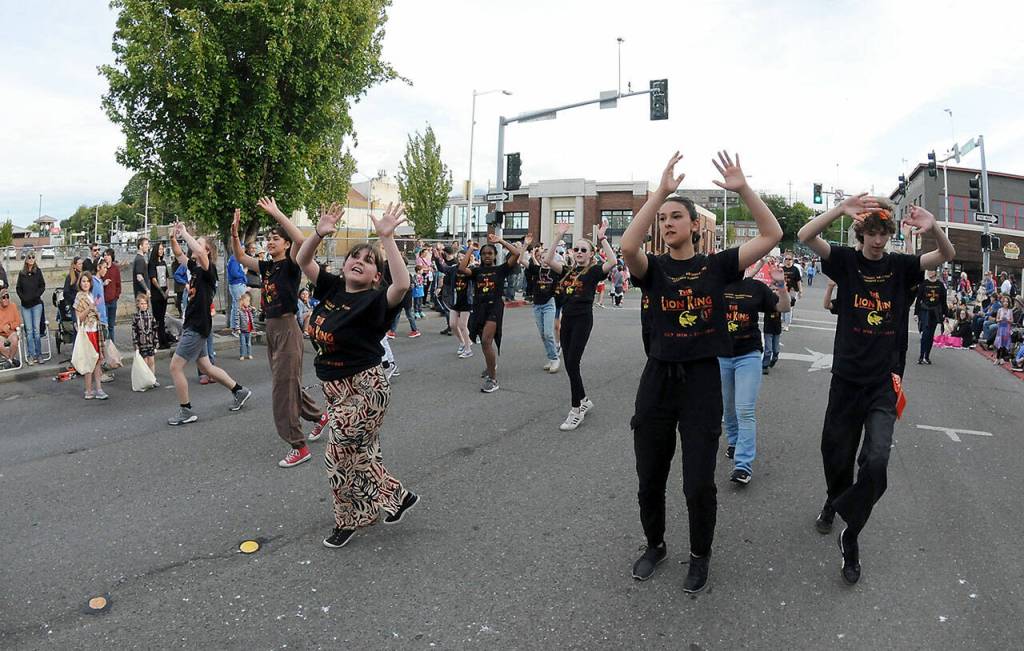 Cast members from the Ghostlight Productions' presentation of "The Lion King Jr." march in Friday's July 4 parade in Port Angeles. (Keith Thorpe/Peninsula Daily News)